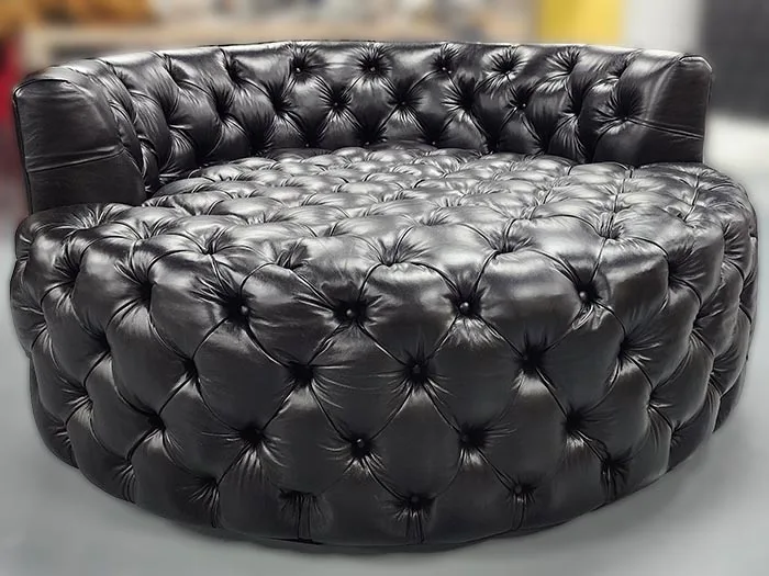 Loveseat-1 — Loveseat in leather, with tufted detailing and a hardwood frame