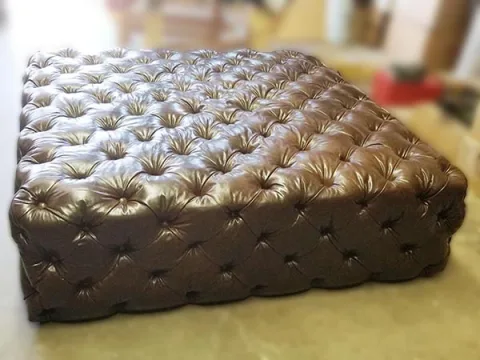 Ottoman-2 — Ottoman in leather, with tufted detailing and a hardwood frame
