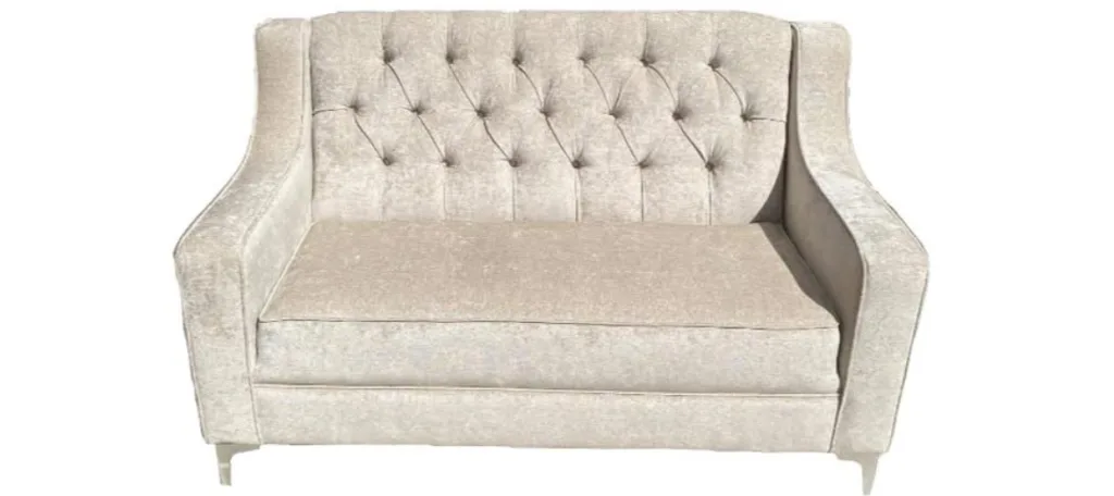 An ivory chenille loveseat with a deep-buttoned back and slim polished legs