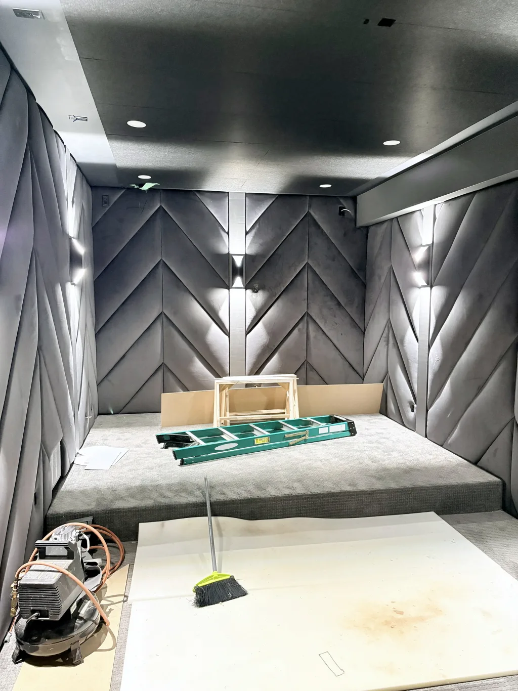 The room part-finished from the doorway, panelling on three walls and the tiered riser waiting for its seating